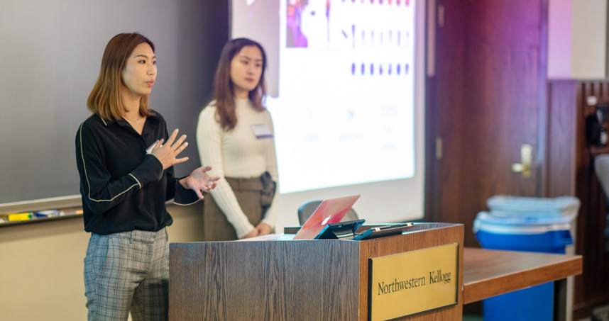 MSIA students Nora Xu (left) and Yiwei Zhang present at the symposium.