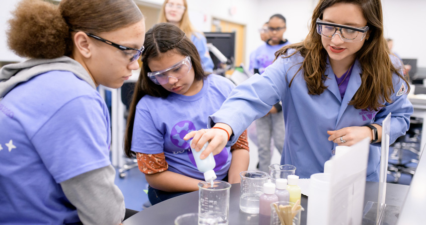 Students observe a materials science experiment.