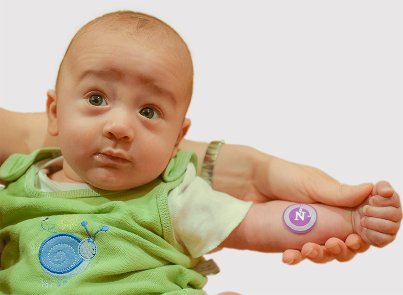 A healthy infant models the device.
