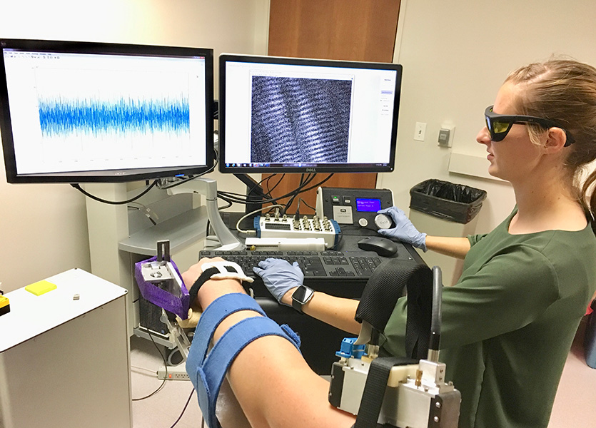 PhD candidate Amy Adkins uses microendoscopy to image sarcomeres (shown on the upper right screen) inside a patient's arm muscle.