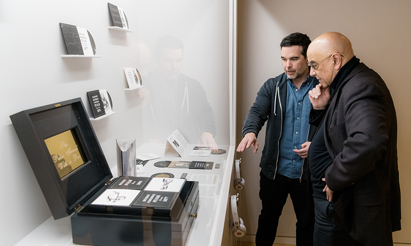 Dean Julio M. Ottino views a part of the exhibition as Dario Robleto discusses his work.