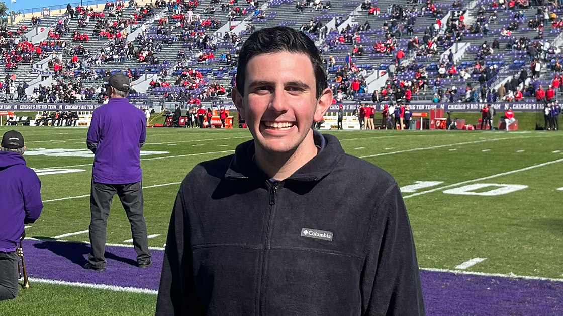 Rothfeder smiles on location during a Northwestern football game.