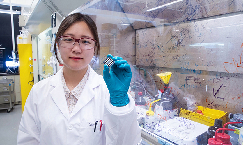 Somin Park holds up a sample of the perovskite solar cell that she and her collaborators designed. When the new cell was measured continuously under solar illumination, it maintained 85 percent of its original performance even following 1,560 hours at 85 degrees Celsius and 50 percent relative humidity.