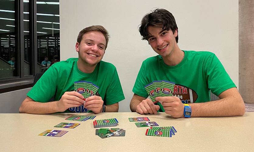 Cameron Briskin, left, and Harrison Brooks pose with cards from Fourth Down.