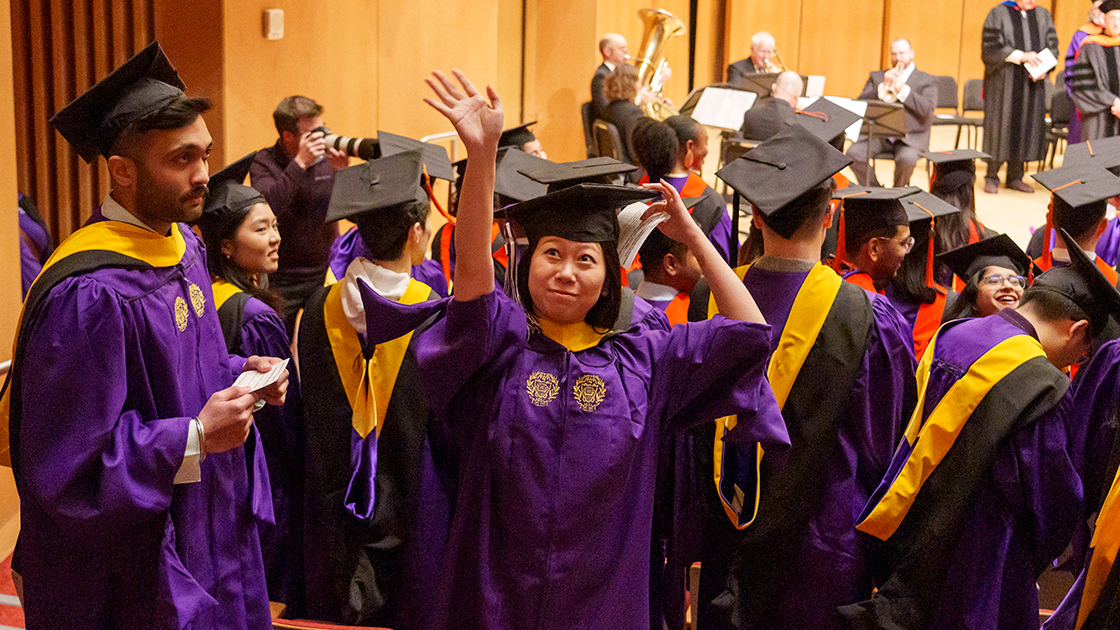 Graduates wave to audience members during the Dec. 9 event.