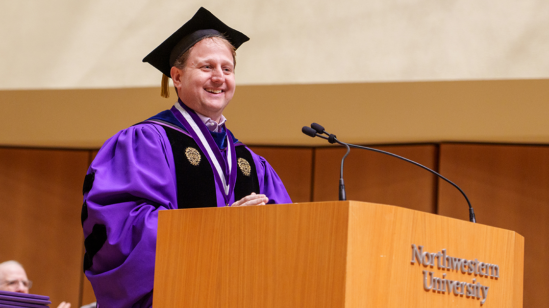 Dean Christopher Schuh smiles during his remarks.