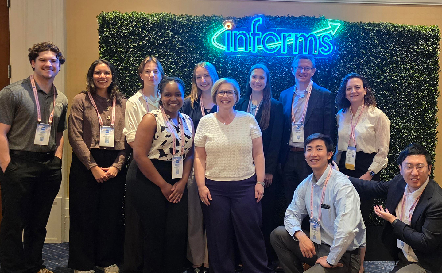 Professors Simge Küçükyavuz and Jill Wilson and associate professor of instruction Michael Watson pose with the group that represented IEMS at the 2026 Analytics+ conference in National Harbor, Md.