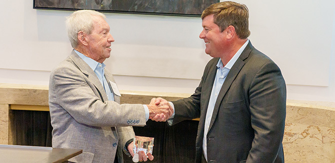 Professor Emeritus William White (L) presents the 2025 IEMS Distinguished Alumni Award to Patrick McCarter (’98).