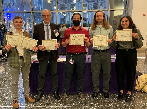 Winners of this year’s Global Health Day poster presentations. From left to right: Daniel Camp, Robert Murphy, MD (standing in for Matthew Caputo), Alexandre Machado de Sant’Anna Carvalho, Eugene Wickett and Maryam Shaaban. Image by Meg Kennedy.