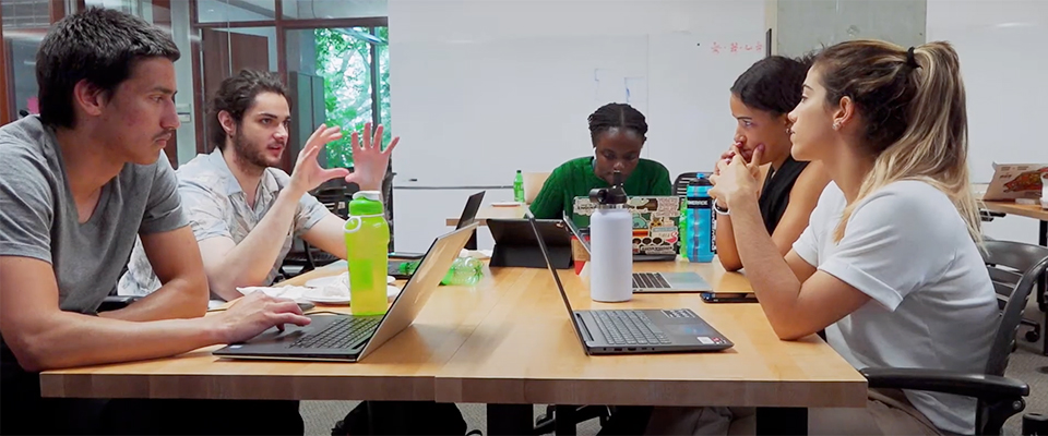 Students collaborating around table