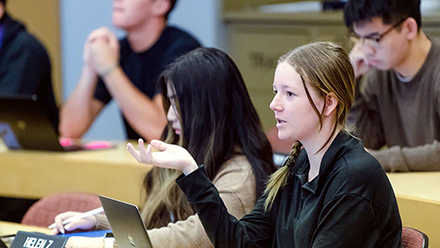 student in class with laptop