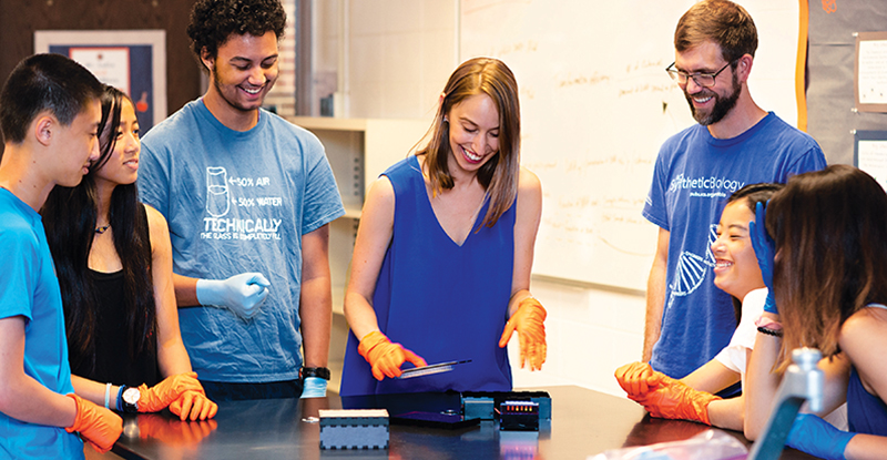 High school students watch Northwestern Engineering’s Jessica Stark (center) and Michael Jewett demonstrate BioBits.