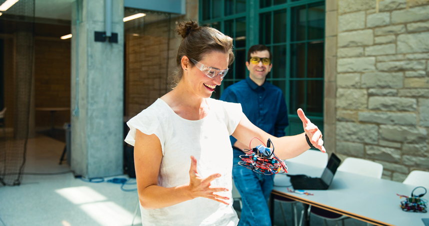 PhD student Ola Kalinowska tests a flying robot with Professor Michael Rubenstein.