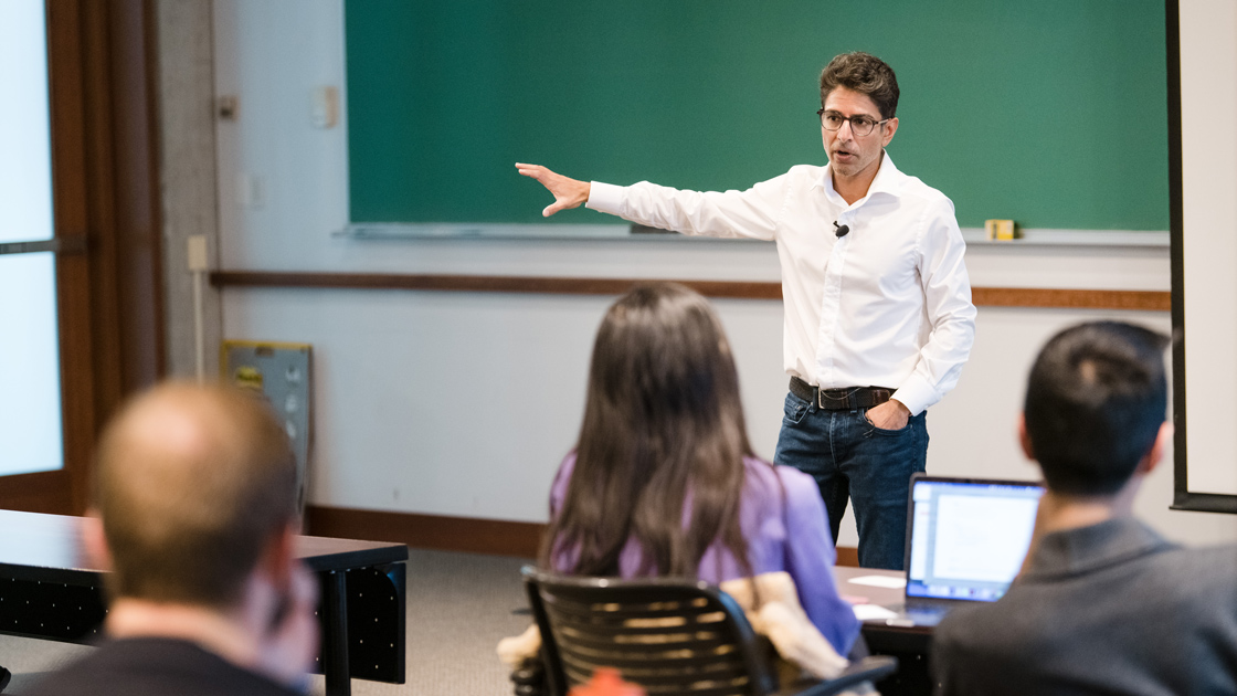 Gupta gesturing to a class during a lecture