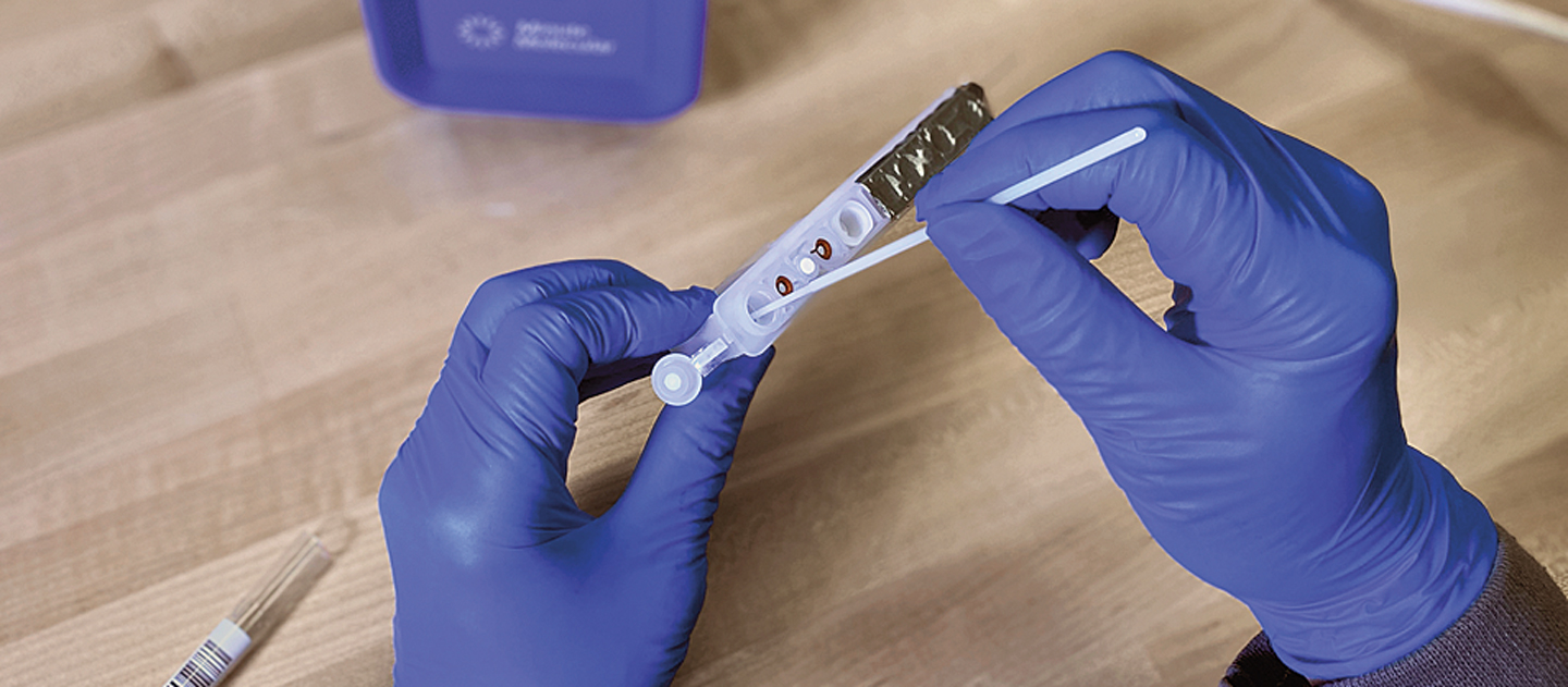 Gloved hands using a PCR test