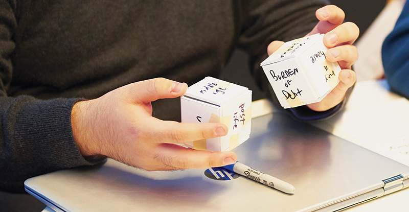 Dice-rolling game designed to jump-start financial discussion among couples participating in concept testing