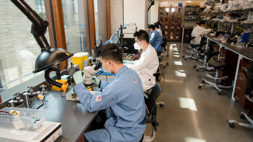 Students work with microscopes and other equipment in the Prototyping Area