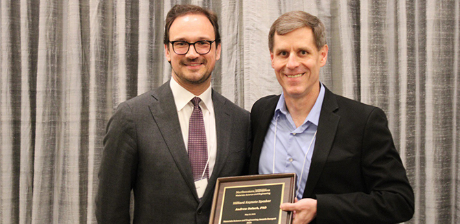 Professor Mark Hersam presents the Hilliard Keynote plaque to Andrew Baluch. 