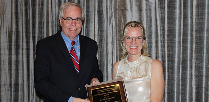 Professor Peter Voorhees presents the Distinguished Career Achievement Award to Carolyn Duran. 