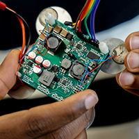 Hands working on circuit board