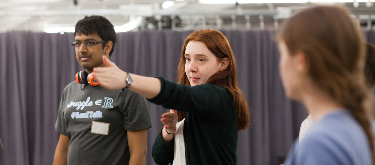 Students gesturing in an improvisational game