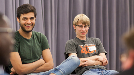 2 students sitting and listening