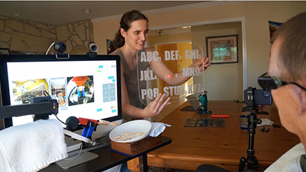 A woman demonstrating a vision test