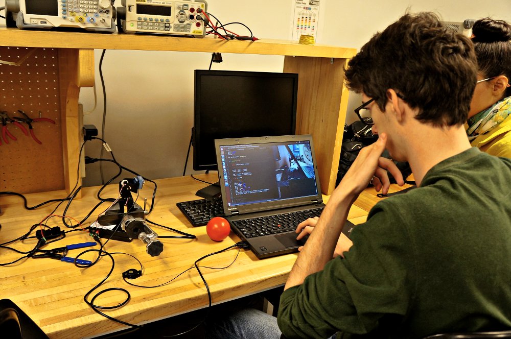 Two MSR students working on their ball-tracking code.